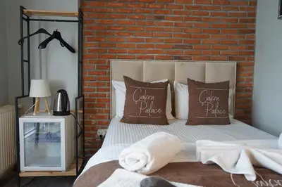 a bedroom with a brick wall and a bed with pillows at The İstanbul Levent Çakra Palace in Istanbul