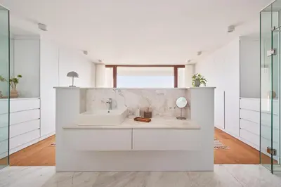 a white bathroom with a sink and a mirror at Stunning Sea View, Peaceful Family Villa with AC, Sauna, Gym & Shared Pool in Silivri