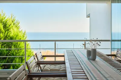 a table with two benches and a view of the ocean at Stunning Sea View, Peaceful Family Villa with AC, Sauna, Gym & Shared Pool in Silivri