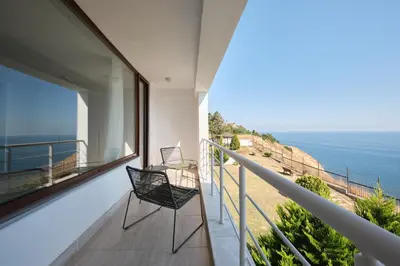 a balcony with two chairs and a view of the ocean at Stunning Sea View, Peaceful Family Villa with AC, Sauna, Gym & Shared Pool in Silivri