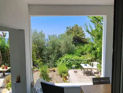a view of a garden through a door at Art & Natura in Marmara