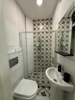 a small bathroom with a toilet and a sink at 24Suitetaksim in Istanbul