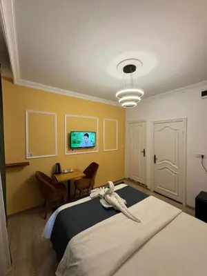a bedroom with a bed and a table and a tv at 24Suitetaksim in Istanbul