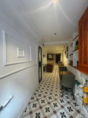 a hallway with a tile floor and a dining room at 24Suitetaksim in Istanbul