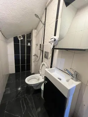 a small bathroom with a toilet and a sink at Taksim Pera Premium Gold Hotel in Istanbul