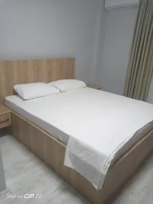 a bed with white sheets and pillows in a room at Tekirdağ Begonya Hotel in Kapaklı