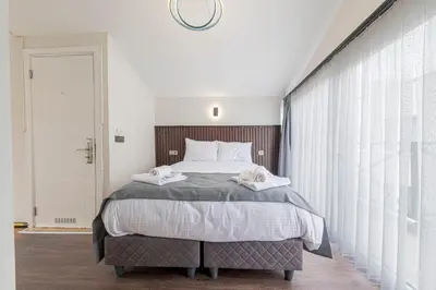a bedroom with a bed with two towels on it at Galata heart suits in Istanbul