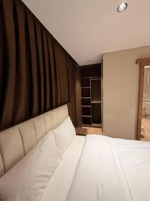 a large white bed in a bedroom with a wall at City Istiklal in Istanbul