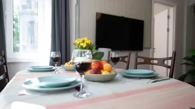 a table with glasses of wine and a bowl of fruit at Taksim Green Flat Apartment 2 in Istanbul