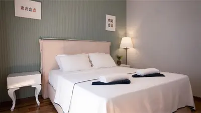 a bedroom with a white bed with two towels on it at Taksim Green Flat Apartment 2 in Istanbul