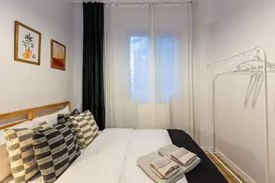 a bedroom with a bed with two pillows and a window at 2BR Historical apartment 5 min to Taksim Sq in Istanbul