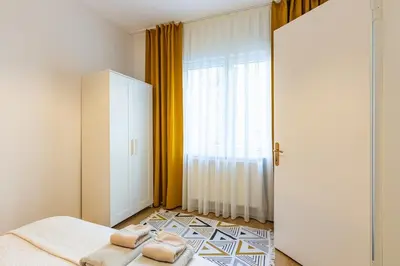 a bedroom with a bed and a large window at 2BR Historical apartment 5 min to Taksim Sq in Istanbul