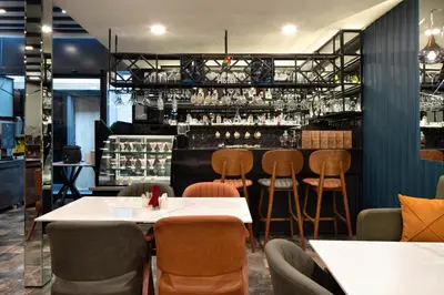 a restaurant with tables and chairs and a bar at Hotel De Bonte in Istanbul