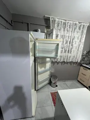 an empty refrigerator in a kitchen with a window at Taksim metro central Suites hotel in Istanbul