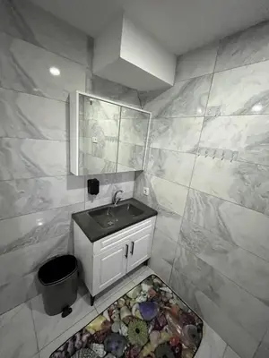 a small bathroom with a sink and a rug at Taksim metro central Suites hotel in Istanbul