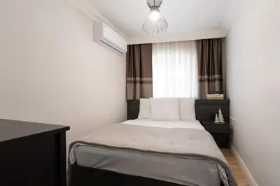 a bedroom with a bed and a chandelier at Premium Family House for 10 Near Taksim in Istanbul