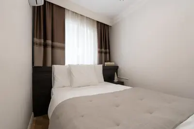 a white bed in a room with a window at Premium Family House for 10 Near Taksim in Istanbul