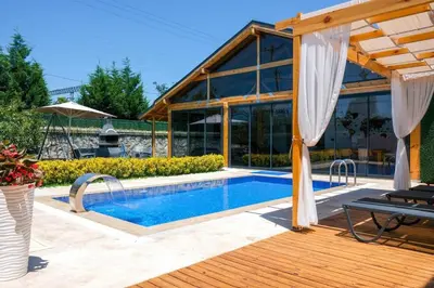 a swimming pool in front of a house at Villa Wonka Sapanca Sıcak Havuz in Sapanca