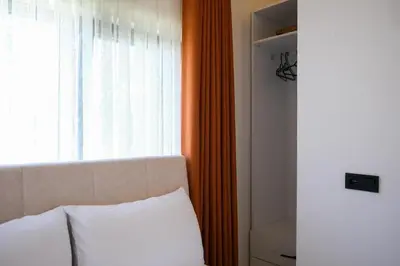a bedroom with a bed and a window with an orange curtain at Villa Wonka Sapanca Sıcak Havuz in Sapanca
