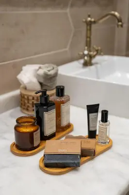 a bathroom counter with several bottles of soap and a sink at Renovated Flat near Tram All Rooms AC in Istanbul