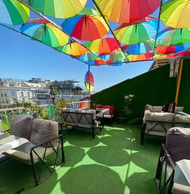 a patio with chairs and umbrellas on a balcony at Boutique Sultan Hotel & Restauran in Istanbul