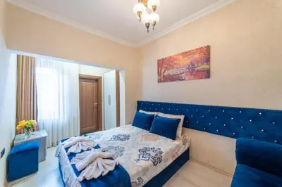 a bedroom with a blue bed with a blue headboard at Boutique Sultan Hotel & Restauran in Istanbul