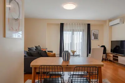 a kitchen and living room with a table and chairs at Spacious 1-Bedroom Apartment with Bosphorus View in Istanbul