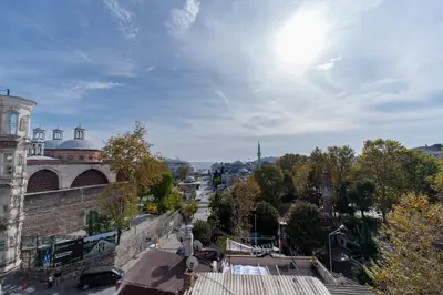 a view of a city with the sun in the sky at Spacious 1-Bedroom Apartment with Bosphorus View in Istanbul