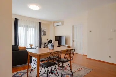 a dining room and living room with a table and chairs at Spacious 1-Bedroom Apartment with Bosphorus View in Istanbul