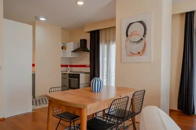 a dining room with a wooden table and chairs at Spacious 1-Bedroom Apartment with Bosphorus View in Istanbul