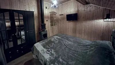 a bedroom with a bed and a television in it at Villa Nest Uludağ in Hüseyinalan