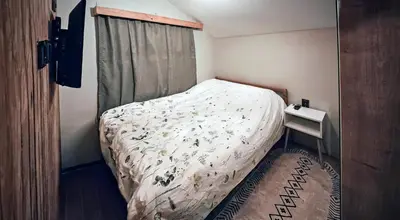 a small bedroom with a bed and a window at Villa Nest Uludağ in Hüseyinalan