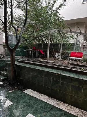 a patio with a bench and a table and a tree at Twin Double X2 Room in Istanbul