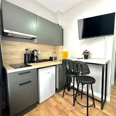 a small kitchen with a counter and stools in it at Accommodation Near the Bull Statue in Kadikoy in Istanbul