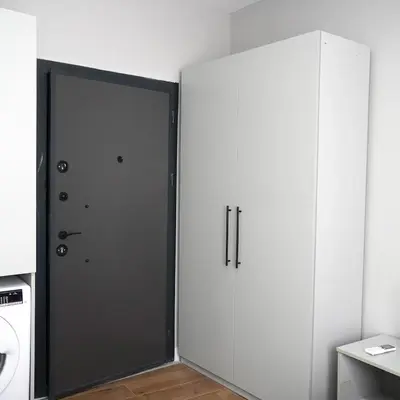 a large door in a room with white cabinets at Accommodation Near the Bull Statue in Kadikoy in Istanbul
