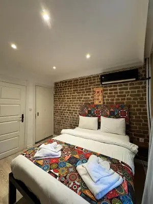 a bedroom with a large bed with towels on it at taksimrosboutique in Istanbul