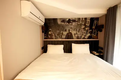 a bed in a room with a picture on the wall at The Diamond City Hotel Yenikapı in Istanbul