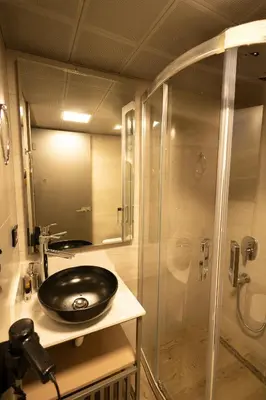 a bathroom with a sink and a shower at The Diamond City Hotel Yenikapı in Istanbul