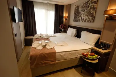 a hotel room with a bed with a bowl of fruit on it at The Diamond City Hotel Yenikapı in Istanbul