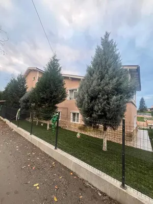a fence in front of a house with trees at Mansion with private pool in Sapanca in Sapanca