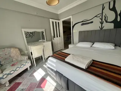 a bedroom with a bed and a chair and a television at Mansion with private pool in Sapanca in Sapanca