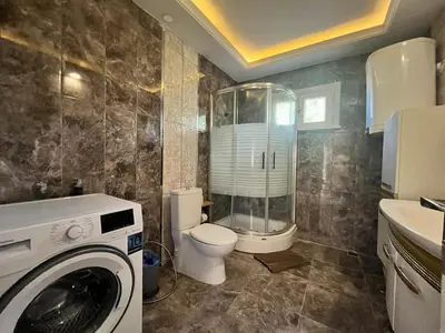 a bathroom with a toilet and a washing machine at Mansion with private pool in Sapanca in Sapanca