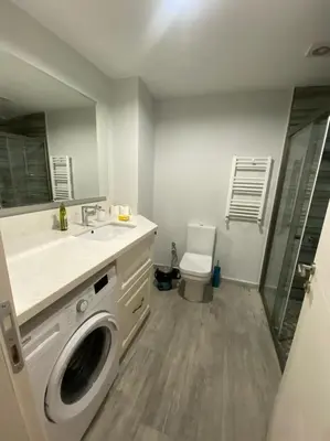 a bathroom with a sink and a washing machine at Breathtaking view apartment in Istanbul