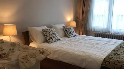 a bedroom with a large white bed with pillows at Apartment on Pier Loti street with a nice view in Istanbul