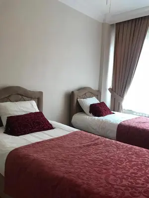 two beds sitting next to each other in a room at Apartment on Pier Loti street with a nice view in Istanbul
