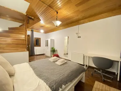 a bedroom with a bed and a desk in it at Historic Lütfi Pasha House in Balat 2BR in Istanbul