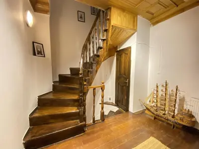 a hallway with a wooden staircase in a house at Historic Lütfi Pasha House in Balat 2BR in Istanbul
