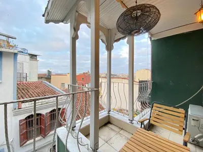 a balcony with a bench and a view of a city at Historic Lütfi Pasha House in Balat 2BR in Istanbul