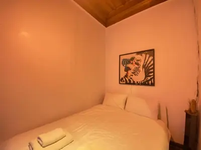 a bed in a room with a picture on the wall at Historic Lütfi Pasha House in Balat 2BR in Istanbul