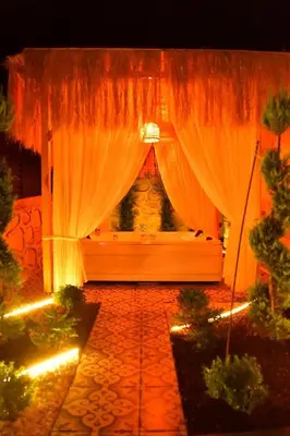 a room with a curtain and some plants and lights at Rubyy Resort Luxury Stone Villa with Private Pool in Kartepe